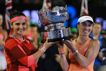 MELBOURNE, AUSTRALIA - JANUARY 30, 2016: Grand Slam champion Sania Mirza of India L and  Martina Hingis of Switzerland during trophy presentation after doubles final match at Australian Open 2016のeditorial素材