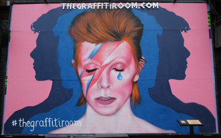 NEW YORK - MARCH 10, 2016: Mural in memory of David Bowie in Little Italy in Manhattan.David Robert Jones, known as David Bowie, was an English singer, songwriter, actor and record producerのeditorial素材