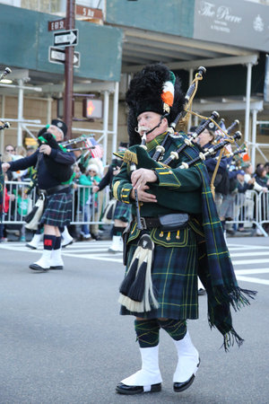 NEW YORK - MARCH 17, 2016: Bagpiper marching at the St. Patrick s Day Parade in New York.