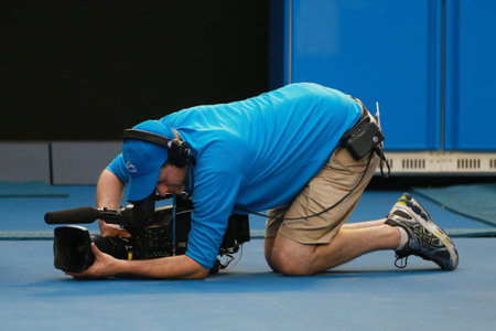 MELBOURNE, AUSTRALIA - JANUARY 28, 2016: Tennis Australia cameraman at Rod Laver arena during...