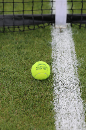 NEW YORK - JULY 21, 2015: Slazenger Wimbledon Tennis Ball on grass tennis court. Slazenger Wimbledon Tennis Ball exclusively used and endorsed by The Championships, Wimbledonのeditorial素材