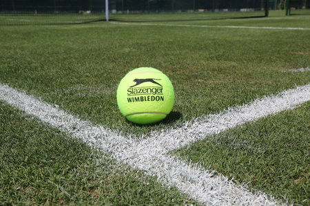NEW YORK - AUGUST 6, 2015: Slazenger Wimbledon Tennis Ball on grass tennis court. Slazenger Wimbledon Tennis Ball exclusively used and endorsed by The Championships, Wimbledonのeditorial素材