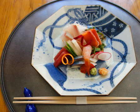 Sashimi dish served in gourmet restaurant. Sashimi is a Japanese delicacy consisting of very fresh raw meat or fish sliced into thin piecesの写真素材