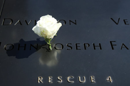NEW YORK - MARCH 6, 2016: Flower left at the National 9/11 Memorial at Ground Zero in Lower Manhattanのeditorial素材