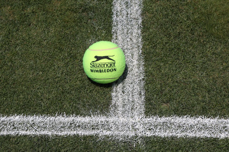 NEW YORK - JUNE 30, 2016: Slazenger Wimbledon Tennis Ball on grass tennis court. Slazenger Wimbledon Tennis Ball exclusively used and endorsed by The Championships, Wimbledonのeditorial素材