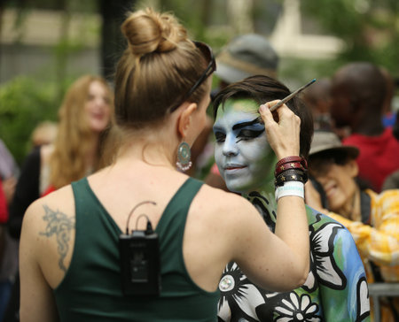 NEW YORK - JULY 9, 2016: Artists paint 100 fully nude models of all shapes and sizes during third NYC Body Painting Day in midtown Manhattan featuring artist Andy Golub in New Yorkのeditorial素材