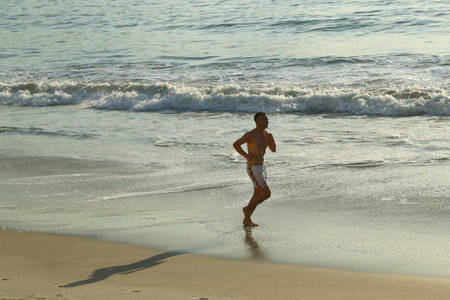 RIO DE JANEIRO, BRAZIL - AUGUST 6, 2016: Unidentified jogger at Copacabana Beach in Rio de Janeiroのeditorial素材