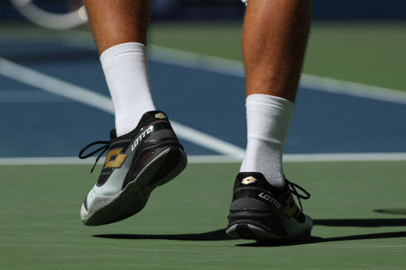 NEW YORK - AUGUST 29, 2016: Professional tennis player Denis Istomin of Uzbekistan wears custom Lotto tennis shoes during match at US Open 2016 at Billie Jean King National Tennis Center in New Yorkのeditorial素材