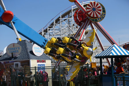 BROOKLYN, NEW YORK - APRIL 13, 2017: Air race ride in Coney Island Luna Park. Riders pilot their own planes around a "control tower" in this spinning ride. Air Race made its world debut at Luna Parkのeditorial素材
