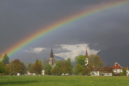 Rainbow over city of Interlaken, Switzerlandの写真素材