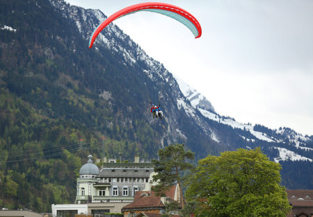 INTERLAKEN, SWITZERLAND - MAY 4, 2017: Tandem paragliding flights over the Swiss Alps in Interlaken, Switzerlandのeditorial素材