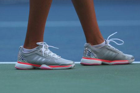 NEW YORK - AUGUST 30, 2016: Professional tennis player Kateryna Kozlova of Ukraine wears custom Adidas by Stella McCartney tennis shoes during match at US Open 2016のeditorial素材