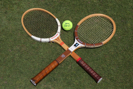 NEW YORK - JUNE 29, 2017:Vintage Tennis rackets and Slazenger Wimbledon Tennis Ball on grass tennis court. Slazenger Wimbledon Tennis Ball exclusively used and endorsed by The Championships, Wimbledonのeditorial素材