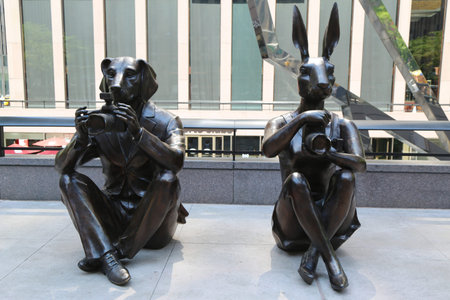 NEW YORK - JULY 20, 2017: Paparazzi Dogman and Paparazzi Rabbitgirl sculpture by world-famous contemporary artists Gillie and Marc at the Avenue of the Americas in midtown Manhattanのeditorial素材
