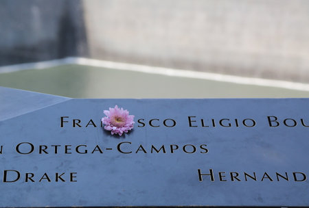 NEW YORK - AUGUST 3, 2017: Flowers left at the National September 11 Memorial at Ground Zero in Lower Manhattanのeditorial素材