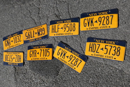 BROOKLYN, NEW YORK - AUGUST 13, 2017: Old car license plates at Brooklyn's largest flea market in DUMBO. In the U.S., where each state issues plates, New York State has required plates since 1901のeditorial素材