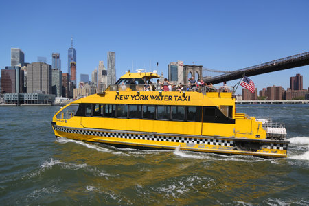 NEW YORK - AUGUST 13, 2017: New York City Water Taxi under Brooklyn Bridge. NYC Water Taxi offering commuter and sightseeing service along the East River and Hudson Riverのeditorial素材