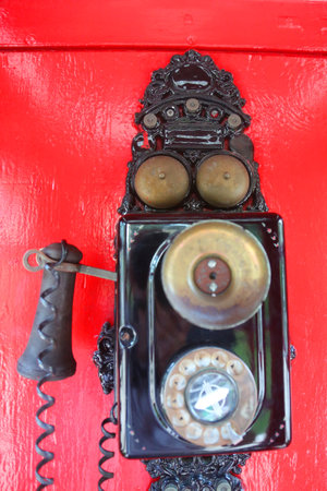 NASSAU, BAHAMAS - DECEMBER 5, 2017: Vintage telephone at English style telephone booth at the Sandals Royal Bahamian Luxury Resort in Nassau, Bahamasのeditorial素材