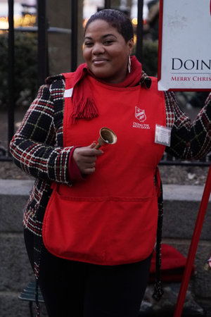 NEW YORK - DECEMBER 19, 2017: Salvation Army soldier performs for collections in midtown Manhattan....