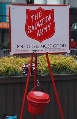 NEW YORK - DECEMBER 19, 2017: Salvation Army soldier performs for collections in midtown Manhattan. This Christian organization is known for its charity work, operating in 126 countriesのeditorial素材