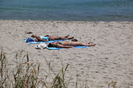 PALM BEACH, FLORIDA - MARCH 21, 2018: Beach goers at Palm Beach, Florida. Palm Beach is a town in South Florida, separated from the mainland by the Lake Worth Lagoonのeditorial素材