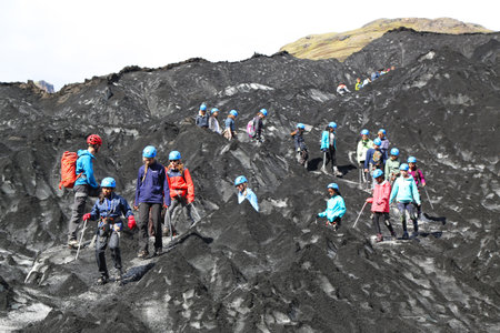 SOLHEIMAJOKULL, ICELAND - JULY 4, 2016: Unidentified hikers during glacier hike at Solheimajokull glacier. Solheimajokull glacier is one of the biggest glaciers in Europeのeditorial素材