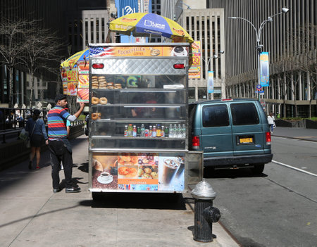 NEW YORK - APRIL 26, 2018: Street food vendor cart in Manhattan. There are about 4,000 mobile food vendors licensed by the cityのeditorial素材