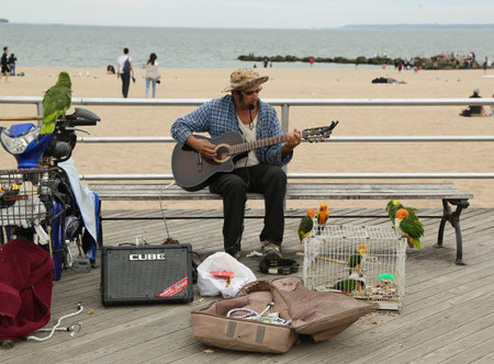 BROOKLYN, NEW YORK - MAY 5, 2018: Street musician performs at the Coney Island Boardwalk in...