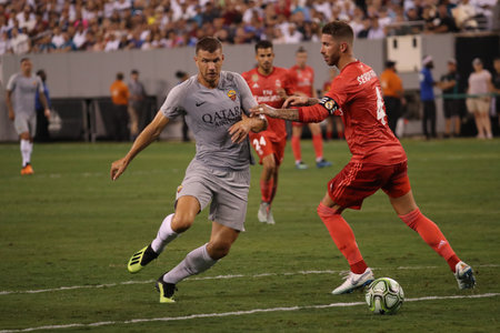 EAST RUTHERFORD, NJ - AUGUST 7, 2018: Edin Dzeko of Roma (L) and Sergio Ramos of Real Madrid #4 in action during the 2018 International Champions Cup match Real Madrid vs Roma at MetLife stadium.のeditorial素材