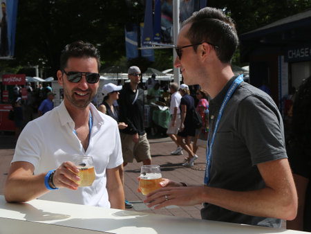 NEW YORK -SEPTEMBER 1, 2018: Tennis enthusiasts make Champagne toast at Billie Jean King National Tennis Center during 2018 US Open. Moet and Chandon is the official champagne of the US Openのeditorial素材
