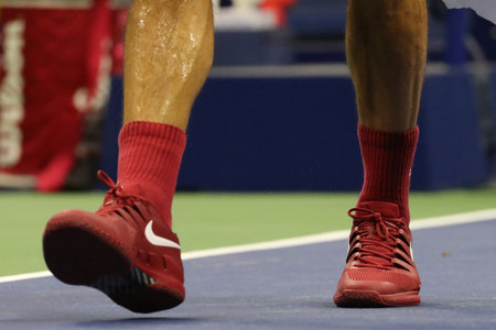 NEW YORK - AUGUST 28, 2018: 20-time Grand Slam champion Roger Federer of Switzerland wears custom Nike tennis shoes during his 2018 US Open first round match at Billie Jean King National Tennis Centerのeditorial素材