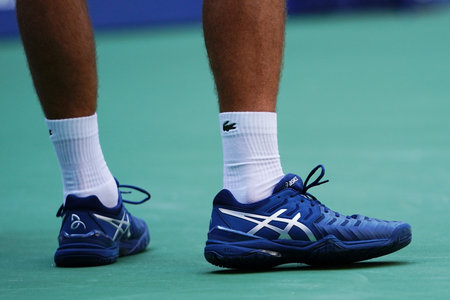 NEW YORK - SEPTEMBER 3, 2018:13-time Grand Slam champion Novak Djokovic of Serbia wears custom Asis tennis shoes during his 2018 US Open match at National Tennis Centerのeditorial素材