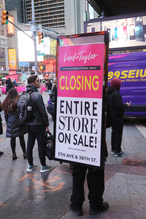 NEW YORK - NOVEMBER 29, 2018: Man wearing a sandwich board about Lord & Taylor 5th Avenue store...