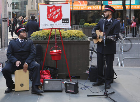 NEW YORK - NOVEMBER 29, 2018: Salvation Army soldier performs for collections in midtown Manhattan....