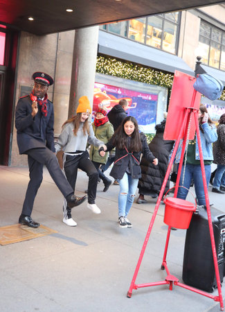 NEW YORK - DECEMBER 6, 2018: Salvation Army soldier performs for collections in midtown Manhattan....
