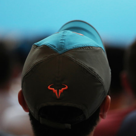 MELBOURNE, AUSTRALIA - JANUARY 24, 2019: Tennis fan wears Rafael Nadal tennis hat during match at 2019 Australian Open in Melbourne Parkのeditorial素材