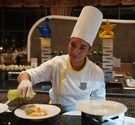 PLAYA DEL CARMEN, MEXICO - JANUARY 5, 2018: Cook preparing food at Iberostar Grand Hotel Paraiso at Playa Del Carmen, Mexicoのeditorial素材