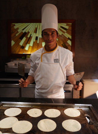 PLAYA DEL CARMEN, MEXICO - JANUARY 5, 2018: Cook preparing food at Iberostar Grand Hotel Paraiso at Playa Del Carmen, Mexicoのeditorial素材