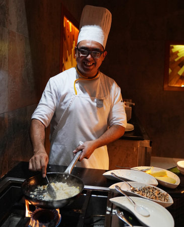 PLAYA DEL CARMEN, MEXICO - JANUARY 5, 2018: Cook preparing food at Iberostar Grand Hotel Paraiso at Playa Del Carmen, Mexicoのeditorial素材
