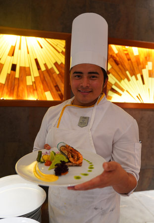 PLAYA DEL CARMEN, MEXICO - JANUARY 5, 2018: Cook preparing food at Iberostar Grand Hotel Paraiso at Playa Del Carmen, Mexicoのeditorial素材