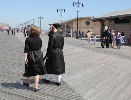 BROOKLYN, NEW YORK - APRIL 23, 2019: Jewish orthodox family enjoy outdoors during Passover at Coney Island in Brooklyn, New Yorkのeditorial素材