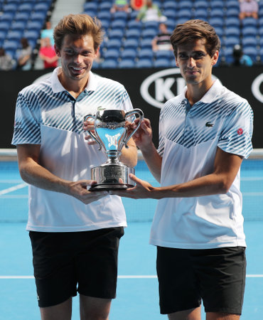 MELBOURNE, AUSTRALIA - JANUARY 27, 2019: Grand Slam Men's Doubles champions Nicolas Mahut (L) and Pierre-Hugues Herbert of France during trophy presentation after 2019 Australian Open final matchのeditorial素材