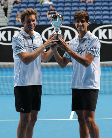 MELBOURNE, AUSTRALIA - JANUARY 27, 2019: Grand Slam Men's Doubles champions Nicolas Mahut (L) and Pierre-Hugues Herbert of France during trophy presentation after 2019 Australian Open final matchのeditorial素材