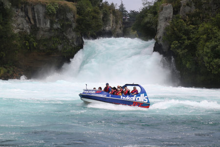 WAIRAKEI, NEW ZEALAND - FEBRUARY, 1, 2019: Hukafalls jet boat takes tourists on fast ride on Waikato River to Huka Falls in Taupoのeditorial素材
