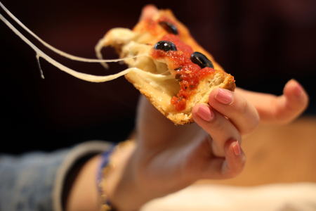 Woman eating Chicago Style Deep Dish Cheese Pizzaの写真素材