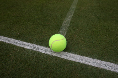Tennis ball on grass tennis courtのeditorial素材