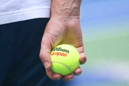 NEW YORK- AUGUST 20, 2019: Tennis coach holding Wilson tennis balls at the Billie Jean King National Tennis Center during 2019 US Open in New Yorkのeditorial素材