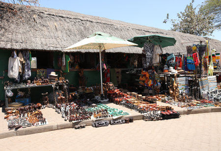 HWANGE, ZIMBABWE - OCTOBER 3, 2018: Local souvenirs on display at the street market near Victoria Falls National Park entrance on the Zimbabwe sideのeditorial素材