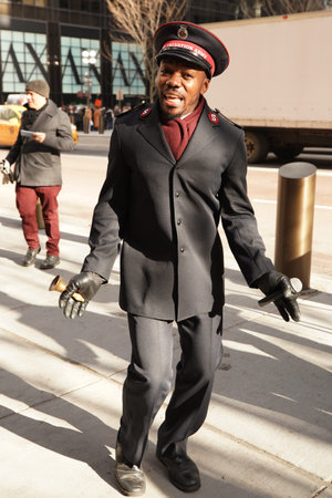 NEW YORK - DECEMBER 5, 2019: Salvation Army soldier performs for collections in midtown Manhattan...