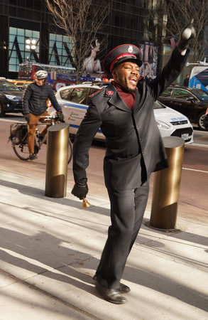 NEW YORK - DECEMBER 5, 2019: Salvation Army soldier performs for collections in midtown Manhattan...